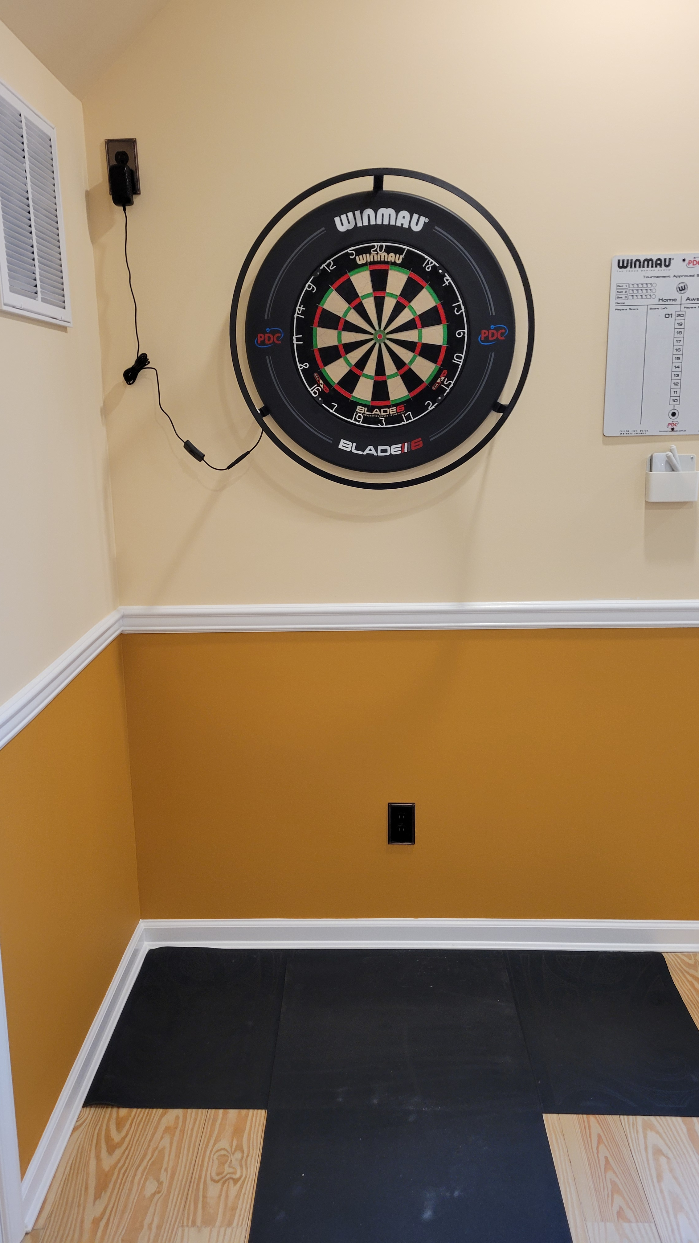 Winmau Plasma dartboard light. Definitely helps you see the entire board better.